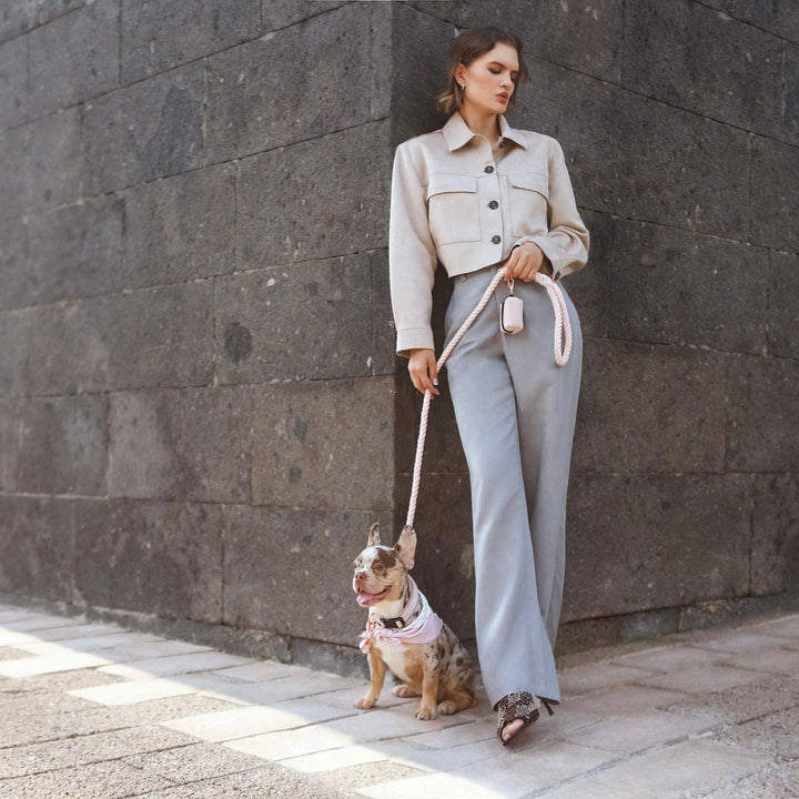 woman standing with a little dog